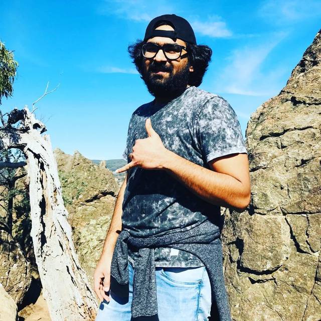 Standing among rock formations under a clear blue sky