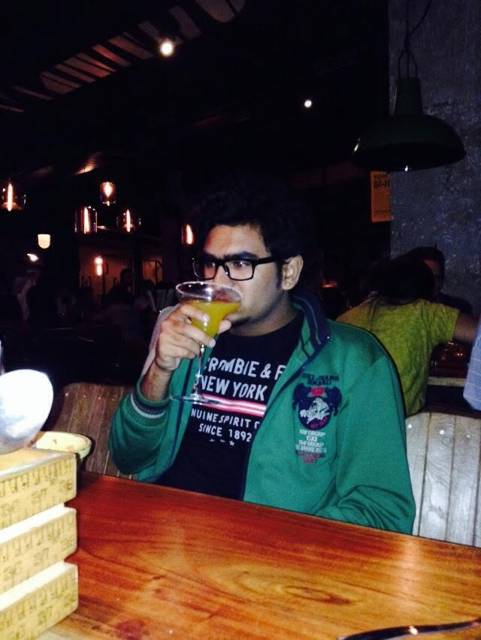 Sipping a drink at a dimly lit restaurant